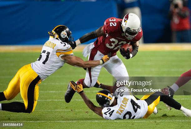 Edgerrin James of the Arizona Cardinal gets tackled by James Farrior and Ike Taylor of the Pittsburgh Steeler in Super Bowl XLIII on February 1, 2009...