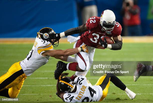 Edgerrin James of the Arizona Cardinal gets tackled by James Farrior and Ike Taylor of the Pittsburgh Steeler in Super Bowl XLIII on February 1, 2009...