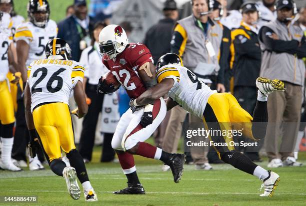 Edgerrin James of the Arizona Cardinal rushing with the ball is tackled by Lawrence Timmons the Pittsburgh Steeler in Super Bowl XLIII on February 1,...