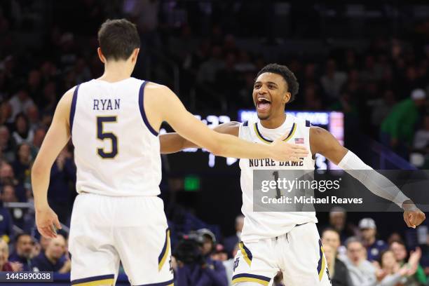 Cormac Ryan and J.J. Starling of the Notre Dame Fighting Irish celebrate a three pointer against the Michigan State Spartans during the first half at...