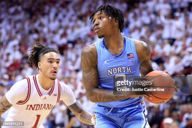 Caleb Love of the North Carolina Tar Heels brings the ball up the court while defended by Jalen Hood-Schifino of the Indiana Hoosiers during the...