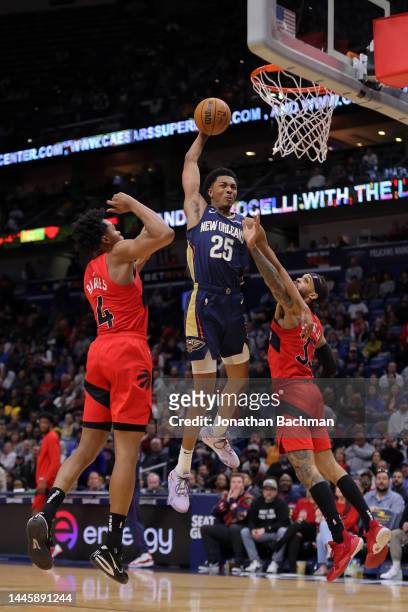 Trey Murphy III of the New Orleans Pelicans drives against Scottie Barnes and Gary Trent Jr. #33 of the Toronto Raptors during the second at Smoothie...