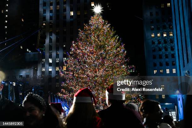 People gather around to watch the 90th annual Rockefeller Christmas Tree lighting on November 30, 2022 in New York City. Despite heavy rain all day,...