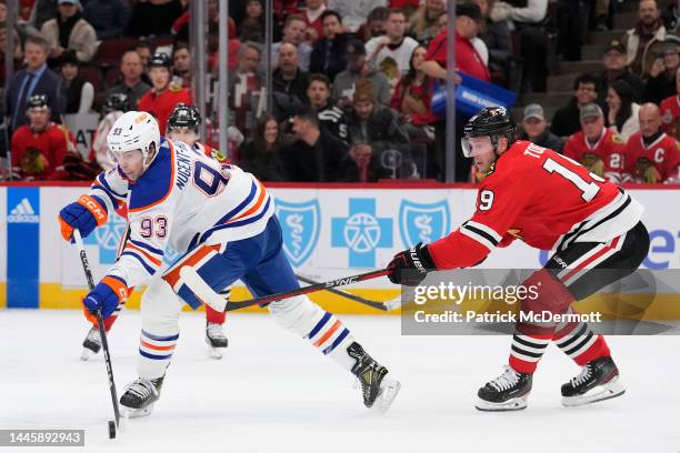 Ryan Nugent-Hopkins of the Edmonton Oilers skates with the puck against Jonathan Toews of the Chicago Blackhawks during the first period at United...