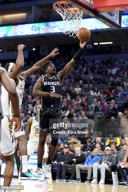 Terence Davis of the Sacramento Kings goes up for a shot on Buddy Hield of the Indiana Pacers at Golden 1 Center on November 30, 2022 in Sacramento,...