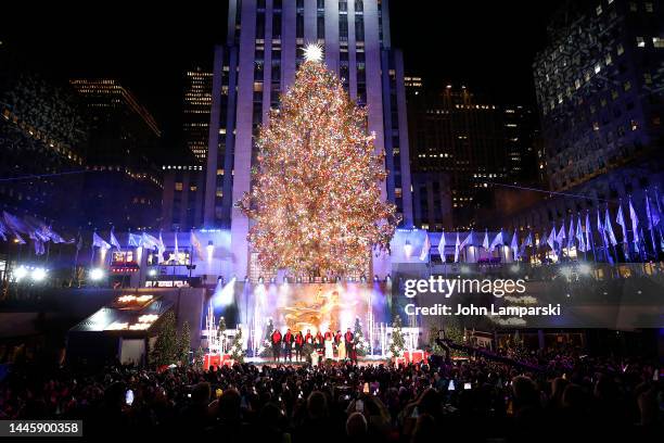 Craig Melvin, Hoda Kotb and Mario Lopez and guests are seen on stage during the 2022 Rockefeller Center Christmas Tree Lighting Ceremony at...