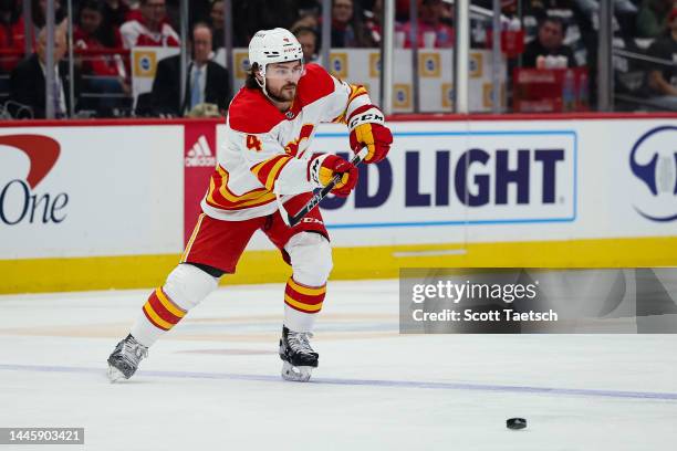 Rasmus Andersson of the Calgary Flames passes the puck against the Washington Capitals during the first period of the game at Capital One Arena on...