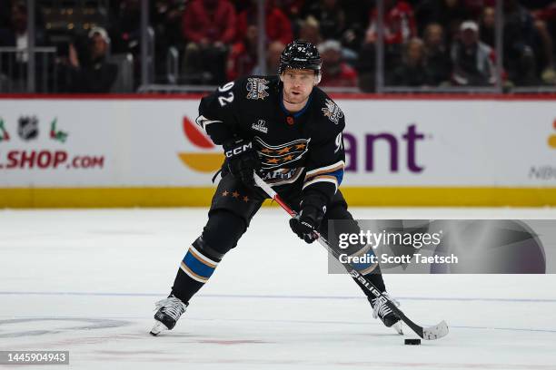 Evgeny Kuznetsov of the Washington Capitals skates with the puck against the Calgary Flames during the second period of the game at Capital One Arena...