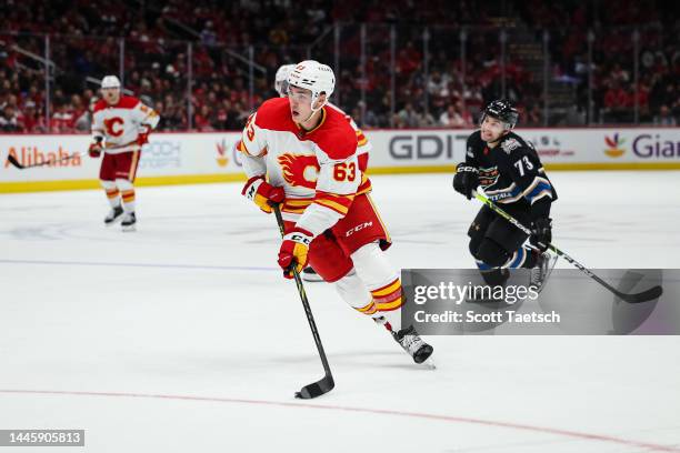 Adam Ruzicka of the Calgary Flames skates with the puck against the Washington Capitals during the third period of the game at Capital One Arena on...