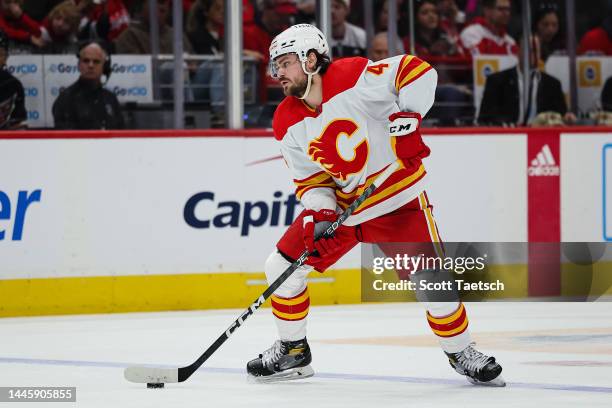 Rasmus Andersson of the Calgary Flames skates with the puck against the Washington Capitals during the third period of the game at Capital One Arena...