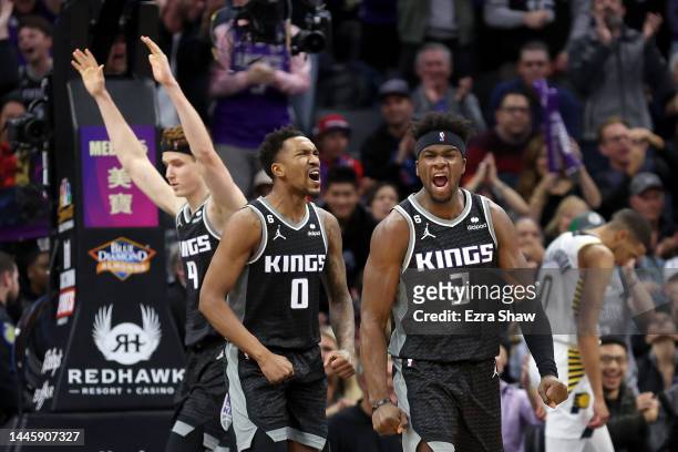 Kevin Huerter, Malik Monk and Terence Davis of the Sacramento Kings react after Huerter made a basket against the Indiana Pacers at Golden 1 Center...
