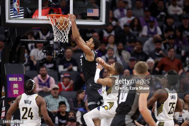 Keegan Murray of the Sacramento Kings dunks the ball on Tyrese Haliburton of the Indiana Pacers at Golden 1 Center on November 30, 2022 in...