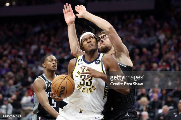 Myles Turner of the Indiana Pacers is guarded by Domantas Sabonis of the Sacramento Kings at Golden 1 Center on November 30, 2022 in Sacramento,...