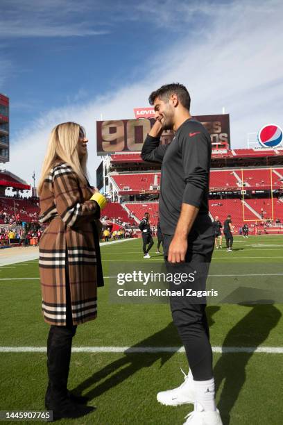 Jimmy Garoppolo of the San Francisco 49ers with broadcaster Laura Okmin on the field before the game against the New Orleans Saints at Levi's Stadium...