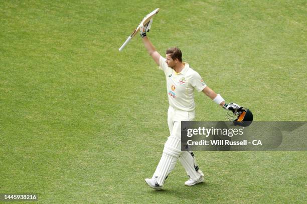 Steve Smith of Australia raises his bat as he leaves the field after the team declared during day two of the First Test match between Australia and...