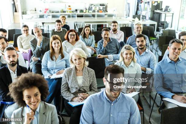 large group of business people attending a training class in a board room. - senior people training imagens e fotografias de stock