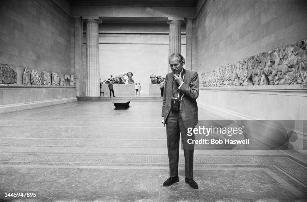 British archaeologist Sir Mortimer Wheeler listening to the newly-available audio guide in the Duveen Gallery of the British Museum in London,...