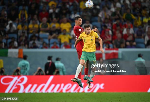 Alexander Bah of Denmark is challenged by Ajdin Hrustic of Australia during the FIFA World Cup Qatar 2022 Group D match between Australia and Denmark...