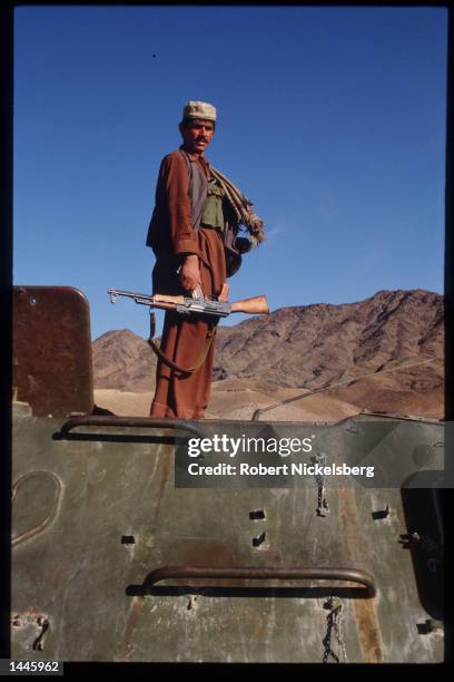 Mujahideen stands on a captured Soviet T-55 tank March 15, 1989 in Jalalabad, Afghanistan. The end of Soviet military occupation, which began in...