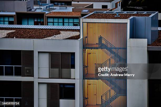 fire escape staircase, apartment at night, electric light - australia economy stock-fotos und bilder