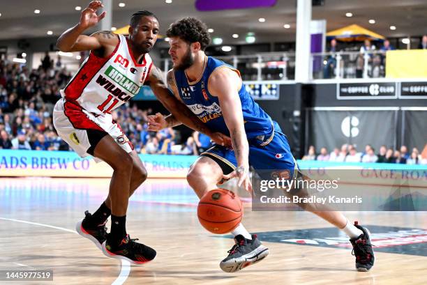 Tyler Johnson of the Bullets takes on the defence of Bryce Cotton of the Wildcats during the round 9 NBL match between the Brisbane Bullets and Perth...