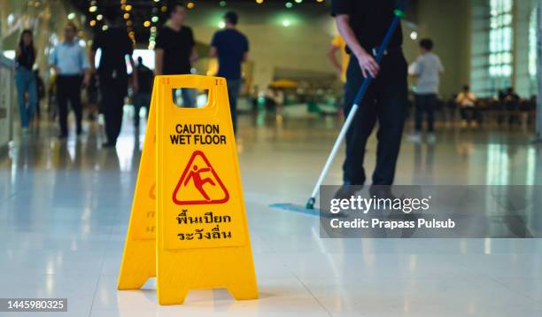 wet floor caution sign on floor - victim services stock pictures, royalty-free photos & images