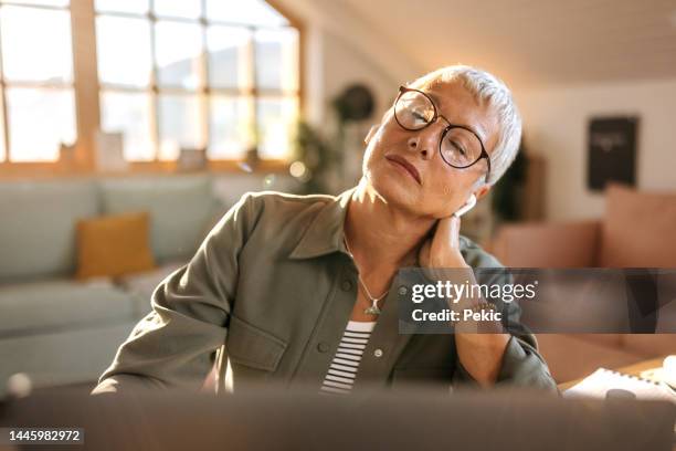 senior woman having neck pain - neckache stock pictures, royalty-free photos & images