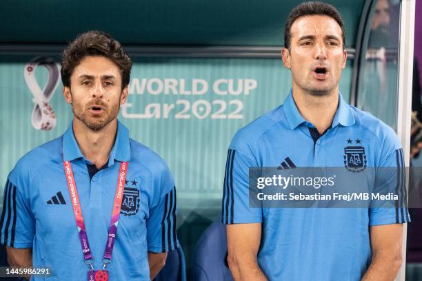 Assistant coach Pablo Aimar of Argentina and Head Coach Lionel Scaloni of Argentina sing the national anthem during the FIFA World Cup Qatar 2022...