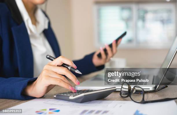 close up of female accountant or banker making calculations. savings, finances and economy concept - bureaucratie photos et images de collection