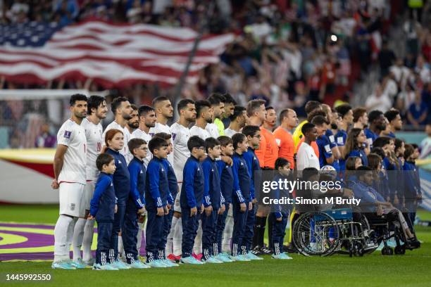 Iran line up to sing the national anthem ahead of the FIFA World Cup Qatar 2022 Group B match between Iran and USA at Al Thumama Stadium on November...