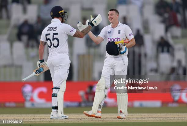Harry Brook of England celebrates with Ben Stokes after reaching his century during the First Test Match between Pakistan and England at Rawalpindi...