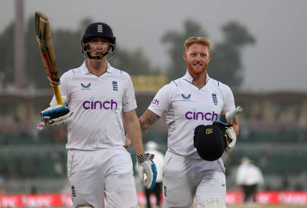 Harry Brook and Ben Stokes of England leave the field at stumps on the First Test Match between Pakistan and England at Rawalpindi Cricket Stadium on...