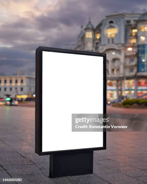blank city format (lightposter, citylight) banner on the sidewalk in the night city street mockup. pylon, a free-standing light box ready for your content - affiche photos et images de collection