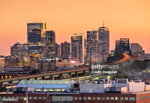 warm sunset glow over the downtown boston city skyline at twilight, massachusetts, usa - boston massachusetts stock pictures, royalty-free photos & images