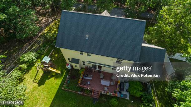detached one-family house in a residential community with patio and playground, view from above on a summer day in poconos, pennsylvania. - pennsylvania house stock pictures, royalty-free photos & images