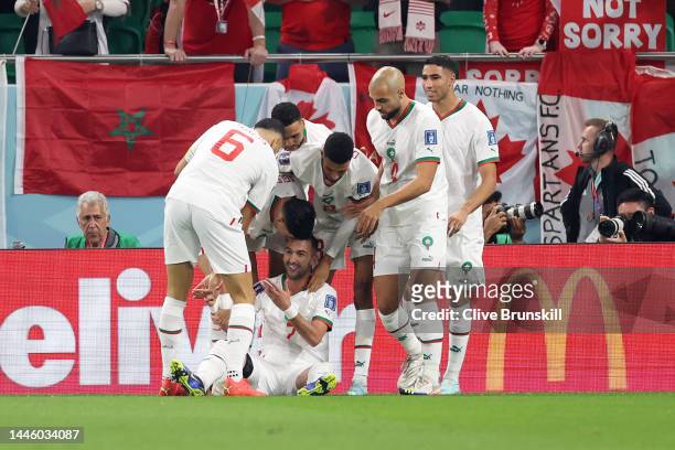 Hakim Ziyech of Morocco celebrates with teammates after scoring the team's first goal during the FIFA World Cup Qatar 2022 Group F match between...