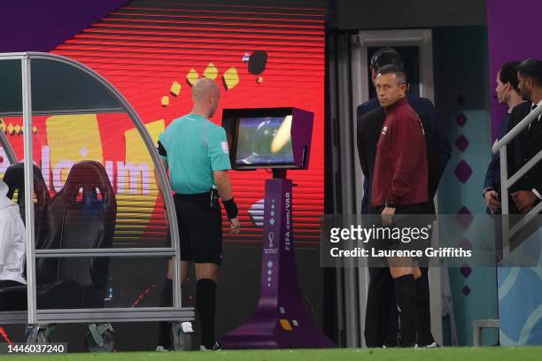 Referee Anthony Taylor checks the VAR screen before ruling out a penalty to Croatia for offside during the FIFA World Cup Qatar 2022 Group F match...