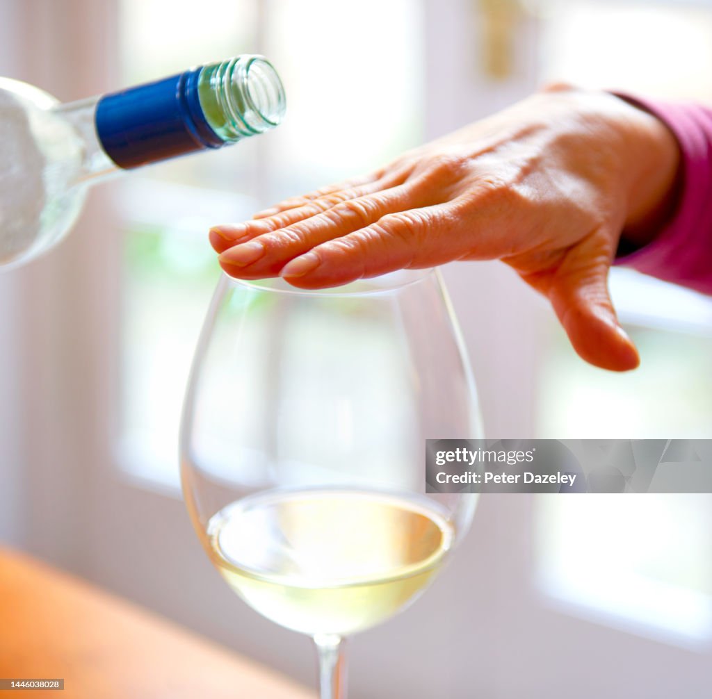 Woman refusing alcohol having reached her limit