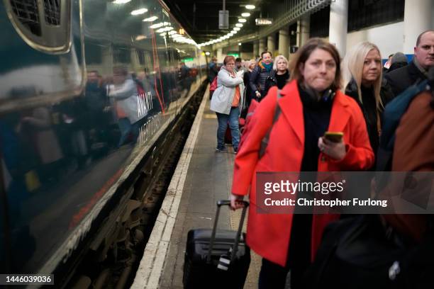 Passengers disembark an Avanti West Coast mainline train at Euston Station on December 01, 2022 in London, England. The Rail, Maritime and Transport...