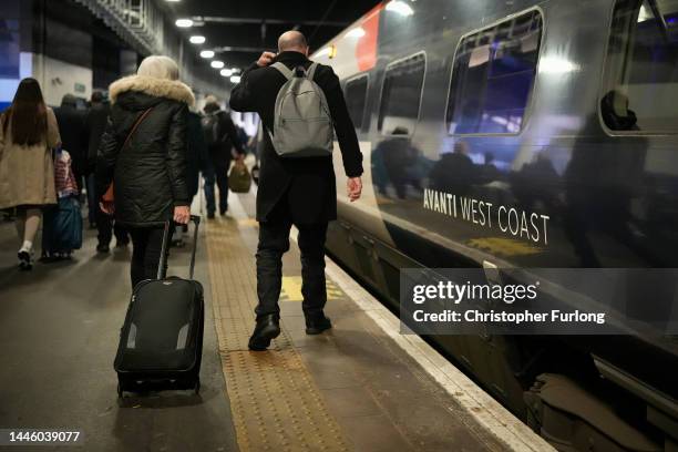 Passengers disembark an Avanti West Coast mainline train at Euston Station on December 01, 2022 in London, England. The Rail, Maritime and Transport...