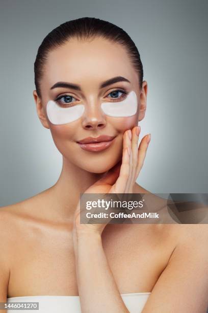 woman with eye patches under her eyes - textile patch stock pictures, royalty-free photos & images