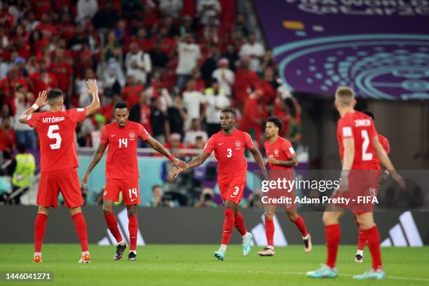 Canada players celebrate their first goal scored an own goal by Nayef Aguerd of Morocco during the FIFA World Cup Qatar 2022 Group F match between...