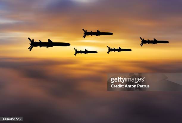 cruise missiles against the sunset sky - cruise missile stockfoto's en -beelden