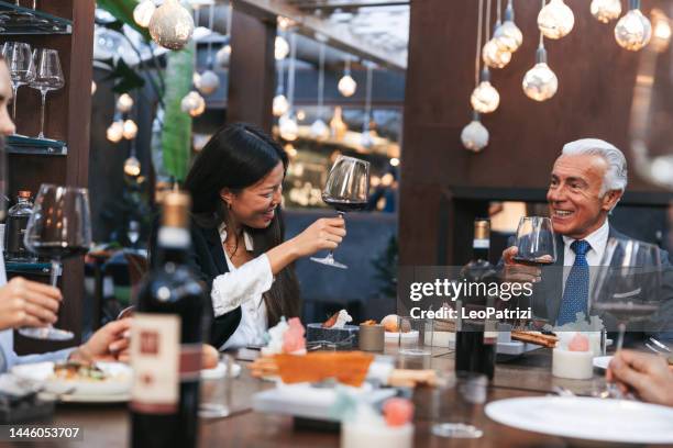 corporate people at a business lunch in a luxury restaurant - business lunch stock pictures, royalty-free photos & images