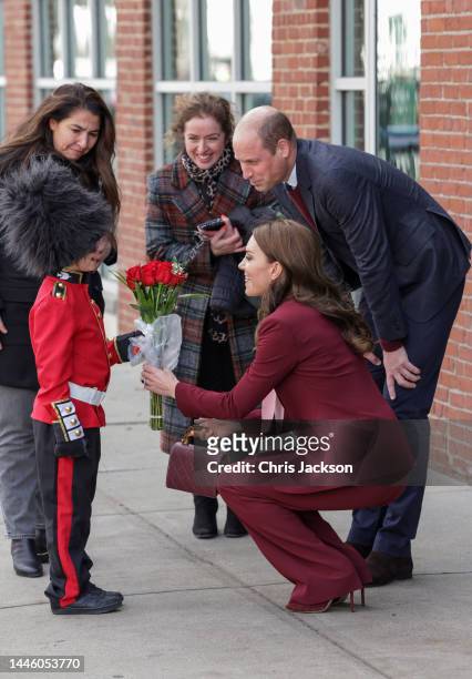 Prince William, Prince of Wales and Catherine, Princess of Wales receive flowers from Henry Dynov-Teixeira as they depart Greentown Labs, North...
