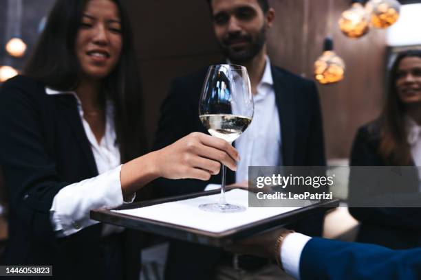 waiter serves champagne at a business meeting - chinese waiter stock pictures, royalty-free photos & images