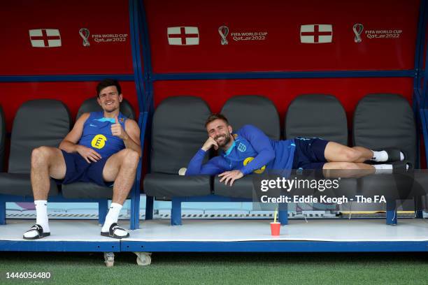 Harry Maguire and Luke Shaw of England pose for a photo for a photograph on the bench during a training session at Al Wakrah Stadium on December 01,...