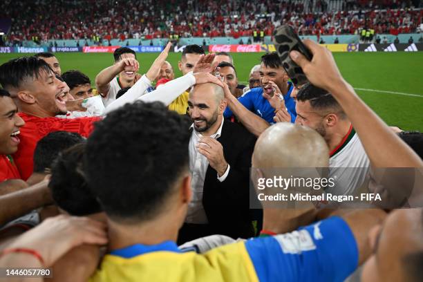 Walid Regragui, Head Coach of Morocco, celebrates with the team after their qualification to the knockout stages during the FIFA World Cup Qatar 2022...