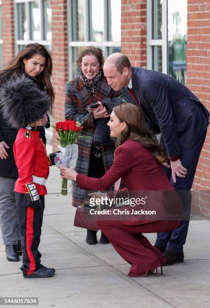 Prince William, Prince of Wales and Catherine, Princess of Wales receive flowers from Henry Dynov-Teixeira as they depart Greentown Labs, North...