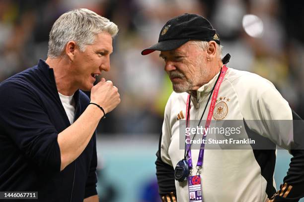 Former player Bastian Schweinsteiger greets assistant coach Hermann Gerland of Germany prior to the FIFA World Cup Qatar 2022 Group E match between...